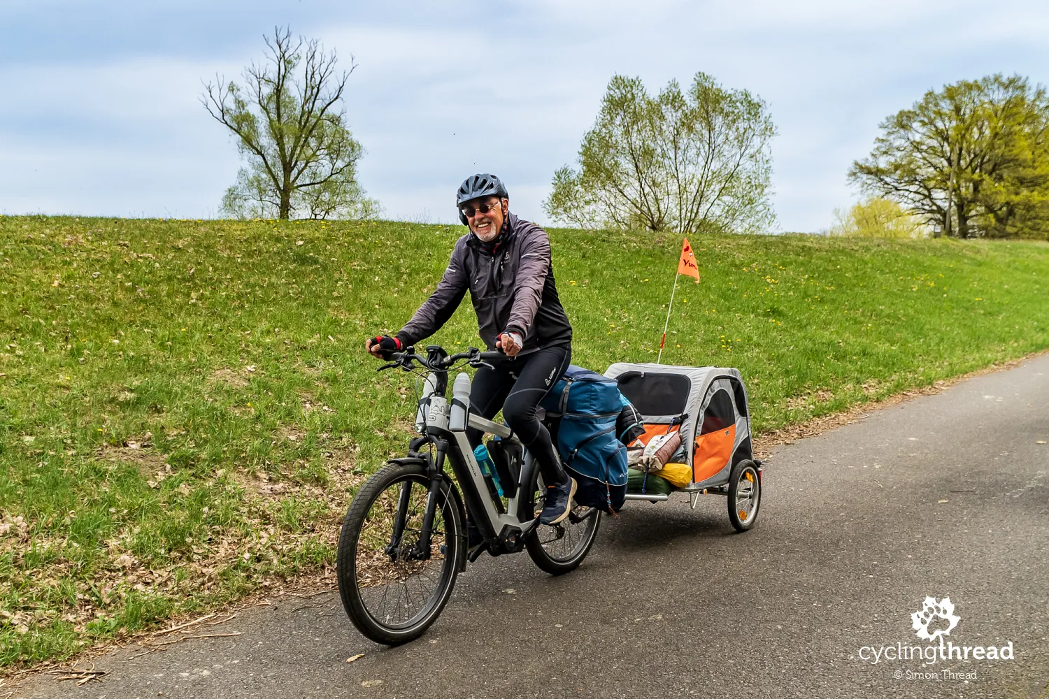 Cyclist with a dog in a trailer