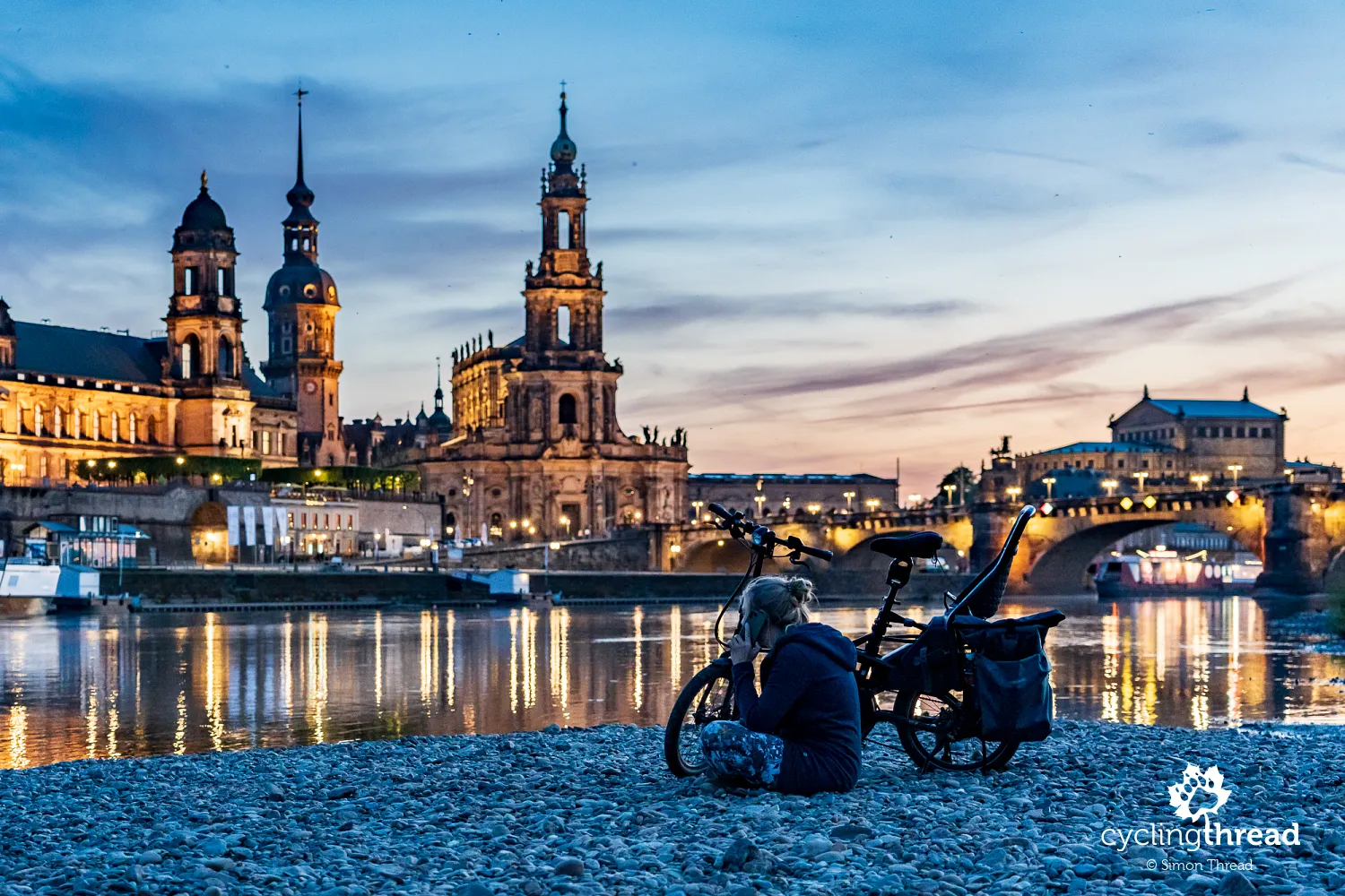 A cyclist with the skyline of Dresden’s Old Town
