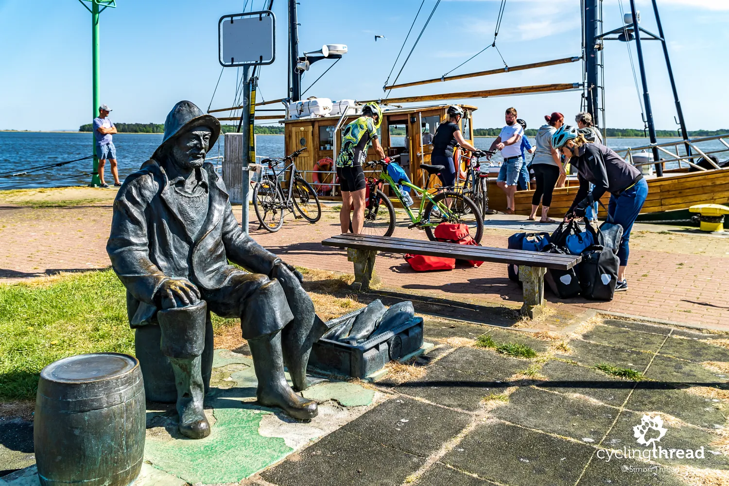 Fisherman’s Monument in Nowe Warpno, the cutter to Altwarp in the background